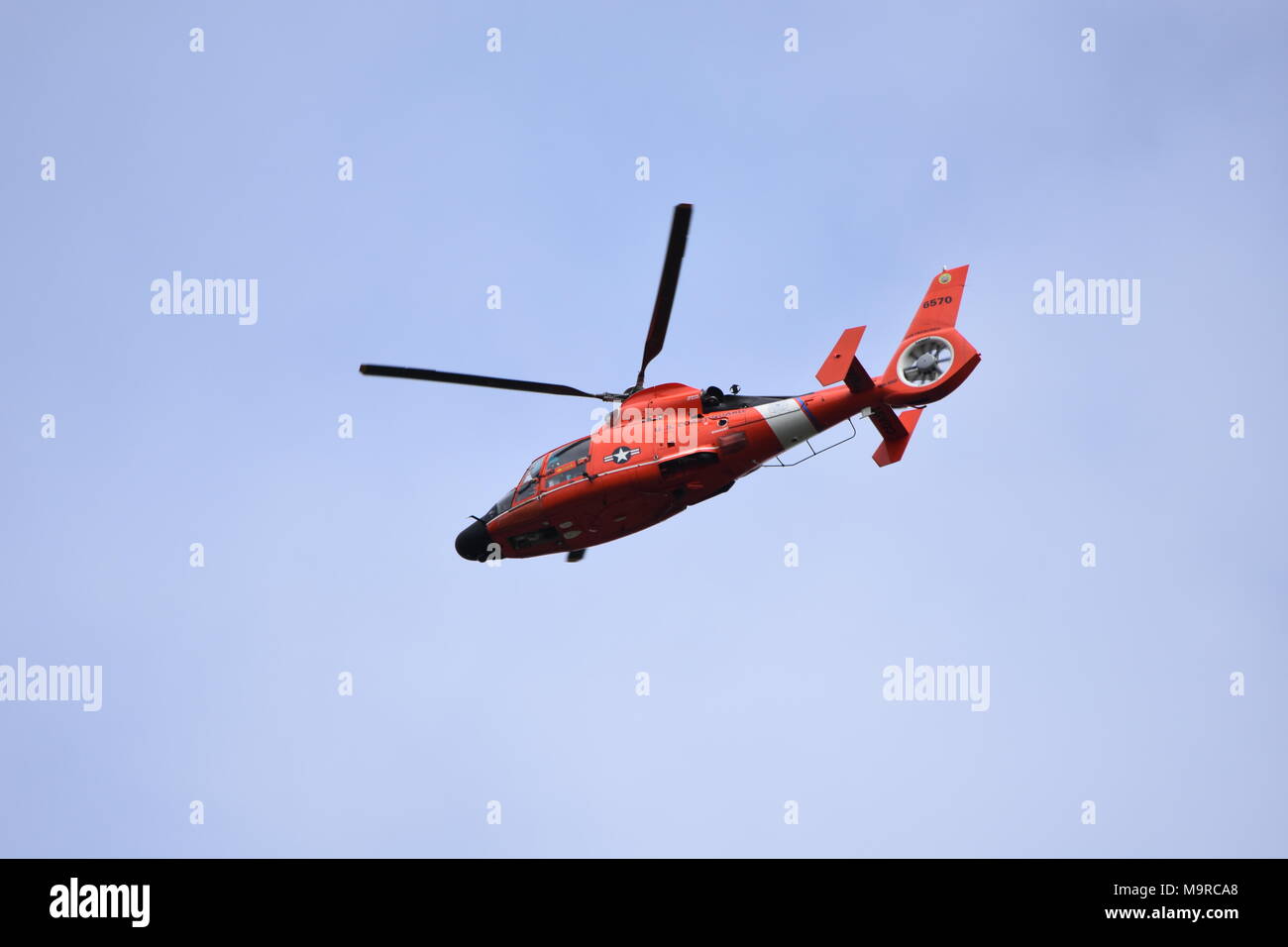 A United States Coast Guard Eurocopter HH-65 Dolphin helicopter flying around Tennessee Valley Beach in Mill Valley, CA. Stock Photo