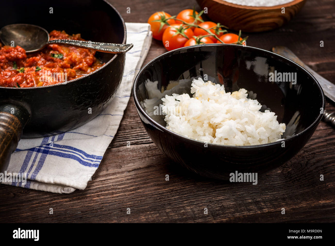 Traditional indian cuisine. Spicy tikka masala with rice on wood table Stock Photo