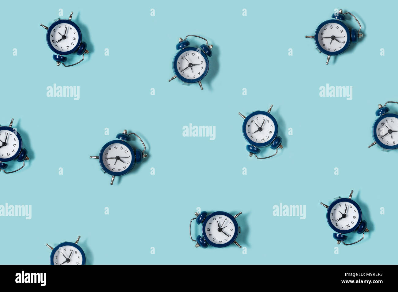 Flat lay retro beautiful new alarm clock on blue color background ...