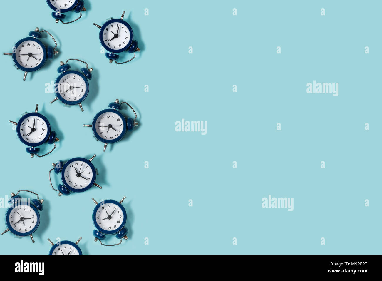 Flat lay retro beautiful new alarm clock on blue color background ...