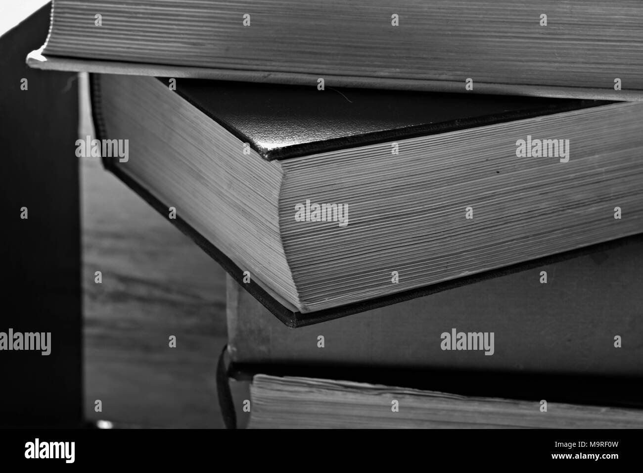 a stack of old dusty books stacked on top of each other Stock Photo