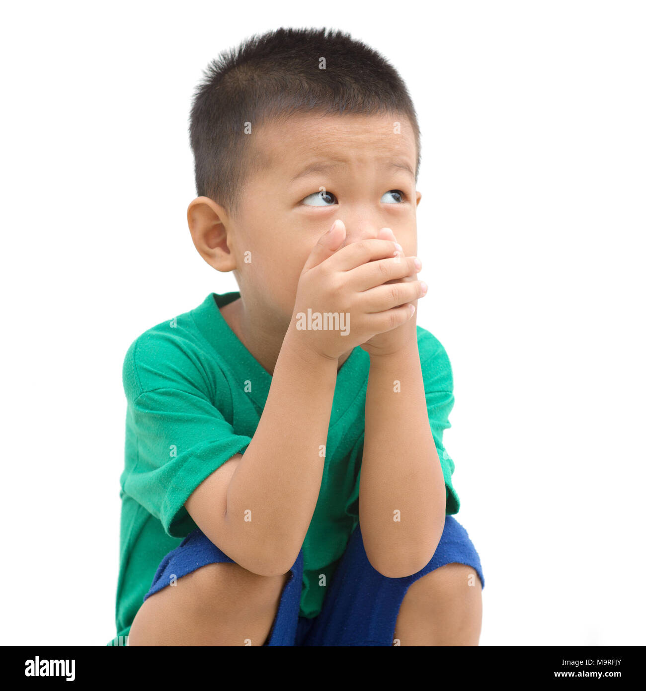 Boy covering mouth hands hires stock photography and images Alamy