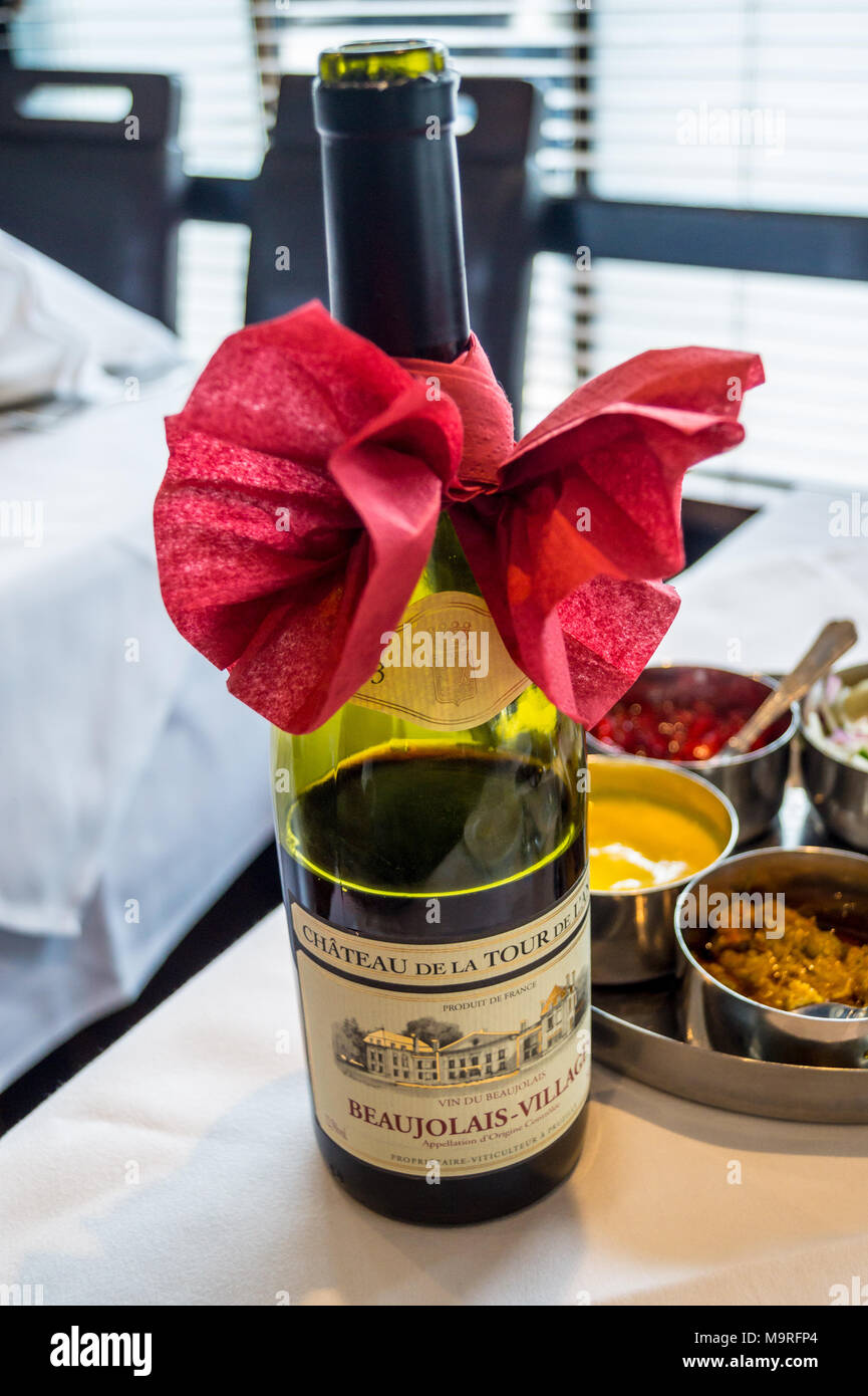 A bottle of Beaujolais-Villages red wine with decorative bow, Spice Masala indian restaurant, formerly Kismet Tandoori, Chipping Ongar, Essex, England Stock Photo