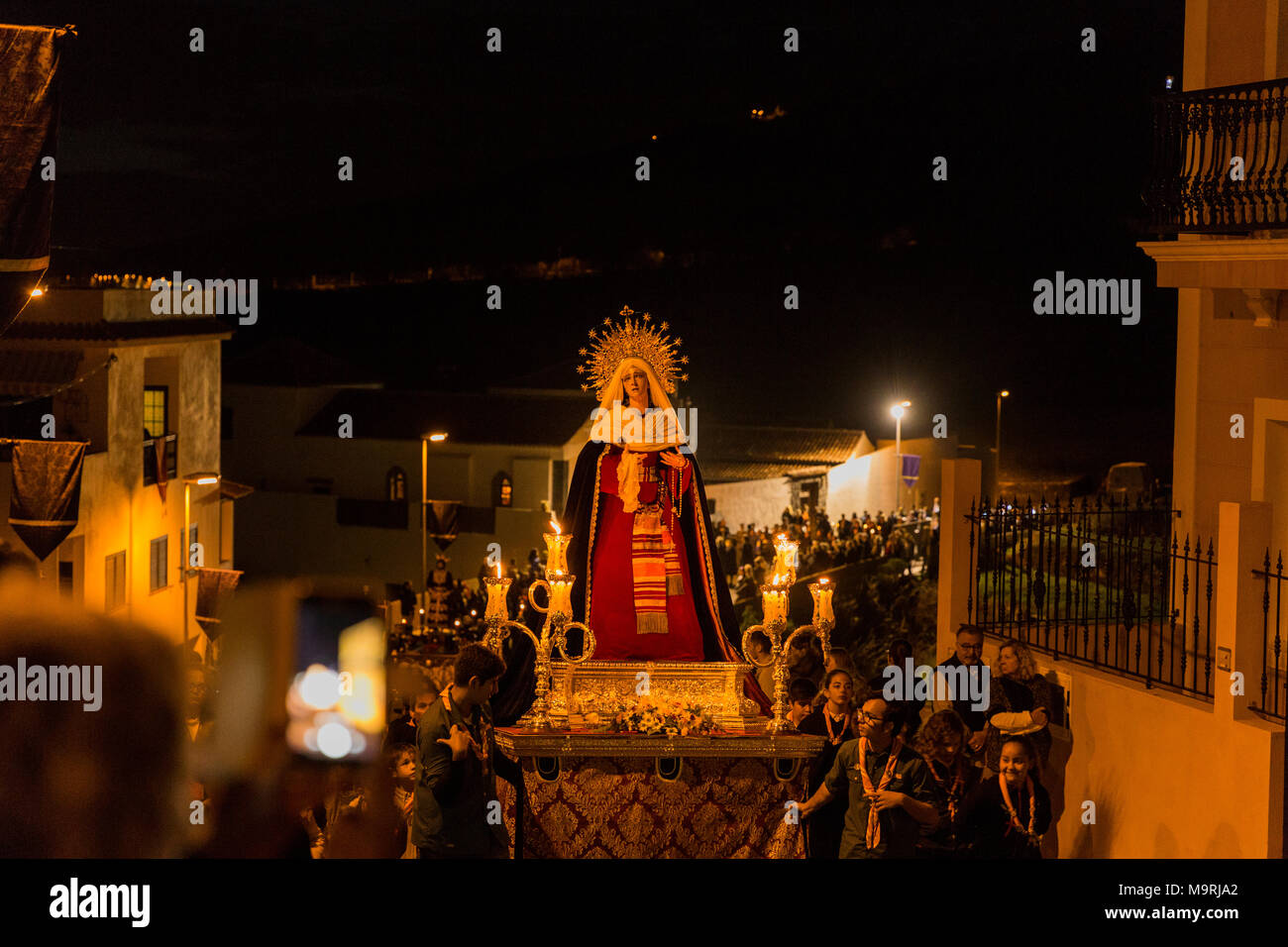 Religious procession in Holy week, through the streets of the old town in Adeje, with lifesize statues of Jesus and the Virgin mary, accompanied by ma Stock Photo