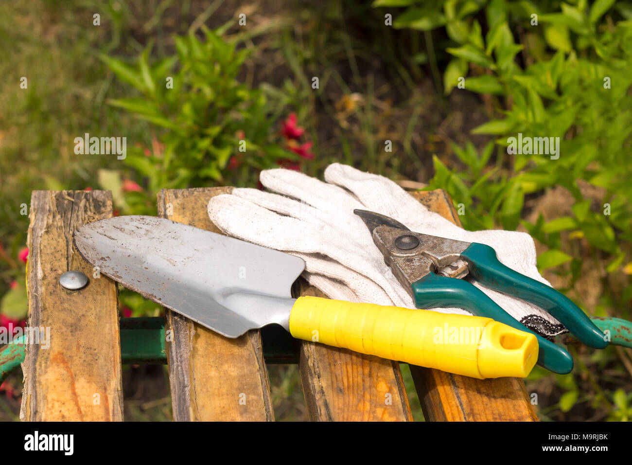 Worked Dirty Garden Tools Composition Laying On A Bench Stock