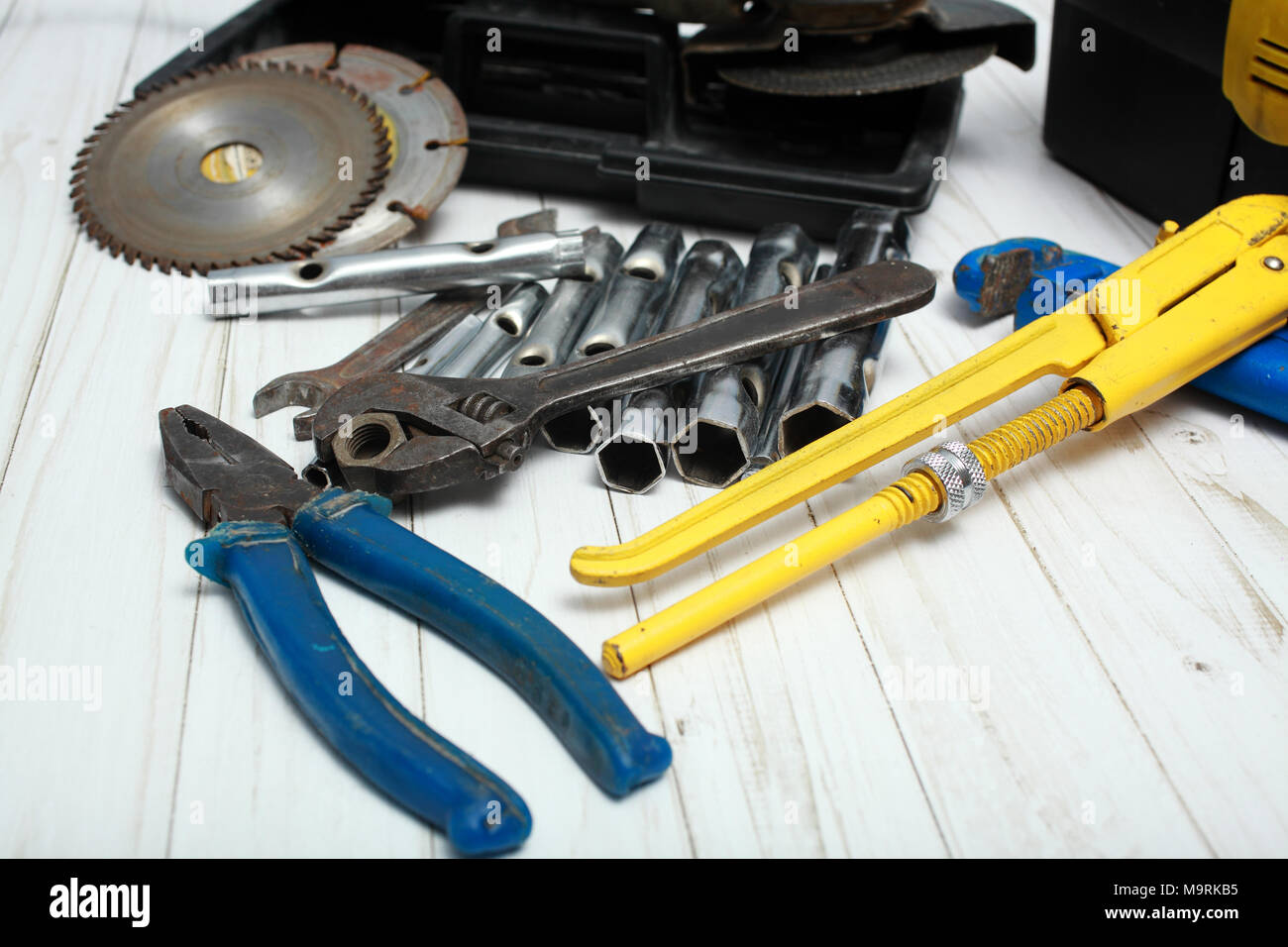 On a white wooden table there are various tools for repair of damages. Stock Photo