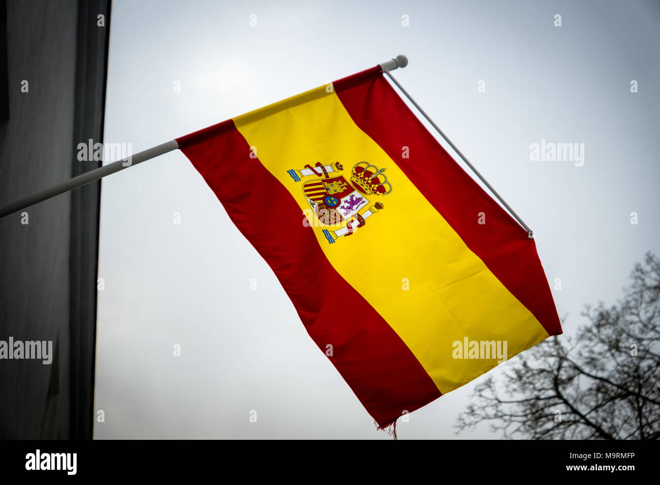 Spanish flag waiving in the air. This flag is the official symbol of the Kingdom of Spain Stock Photo