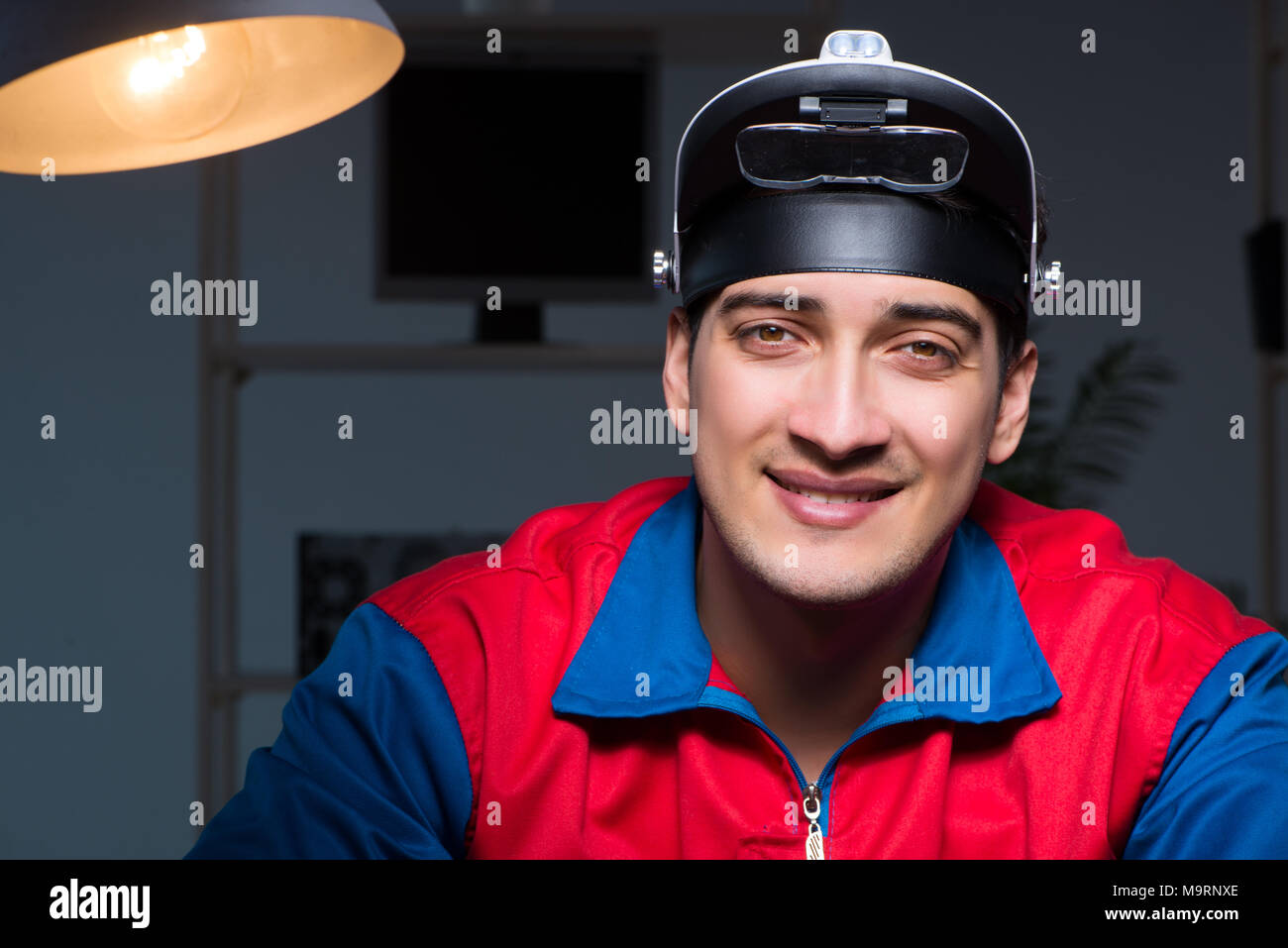 Computer specialist repairing PC late at night Stock Photo - Alamy