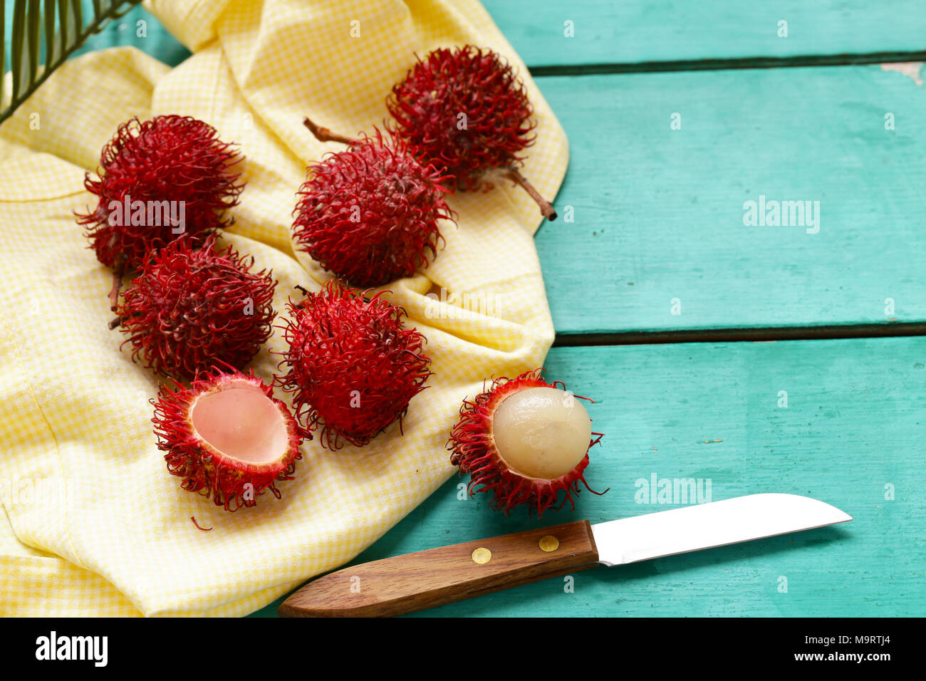 fresh tropical fruit rambutan on a wooden background Stock Photo - Alamy