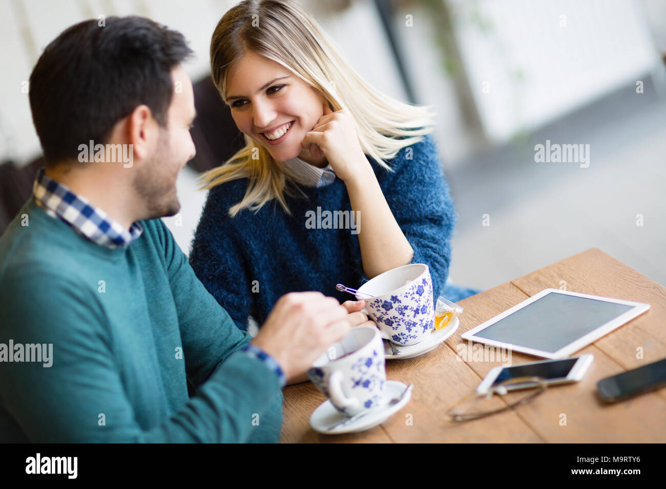 Young attractive couple on date in coffee shop Stock Photo
