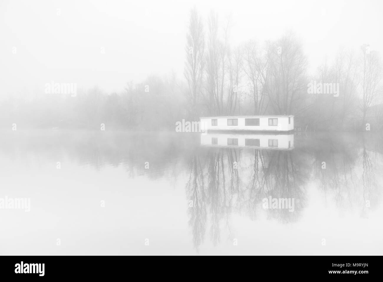 Desolate Houseboat in the fogg on the ringvaart in Amsterdam, the Netherlands. Stock Photo