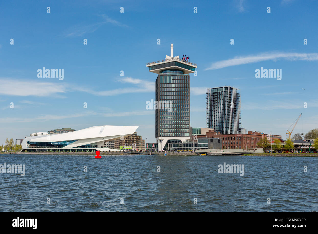 EYE Filmuseum and the A'DAM Lookout tower over 't IJ river on a sunny day in Amsterdam Noord in The Netherlands. Stock Photo
