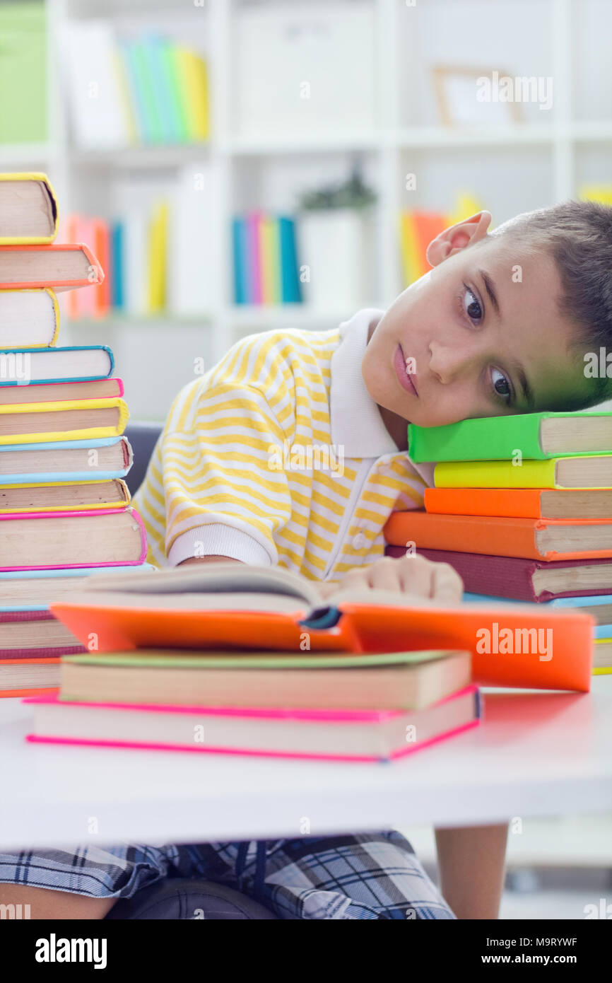 Young boy is tired from a lot of learning Stock Photo