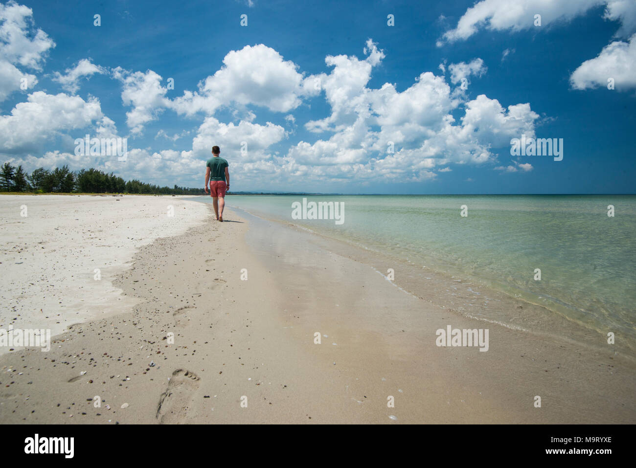 A man walking along a shore, Kudat, Sabah, Malaysia, Borneo, Stock Photo