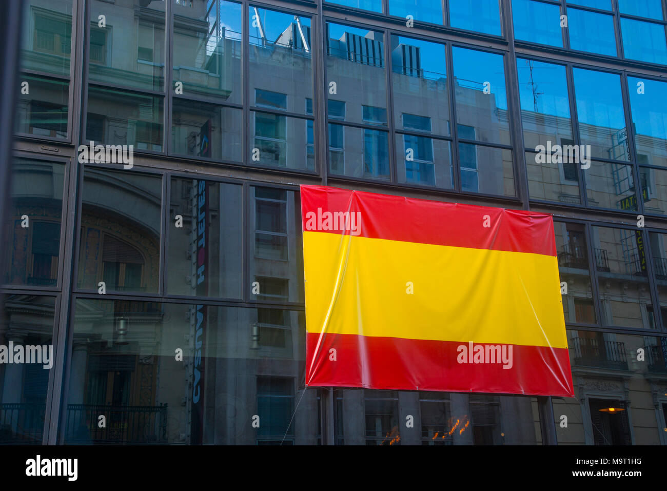 Spanish flag on glass facade. Madrid, Spain. Stock Photo