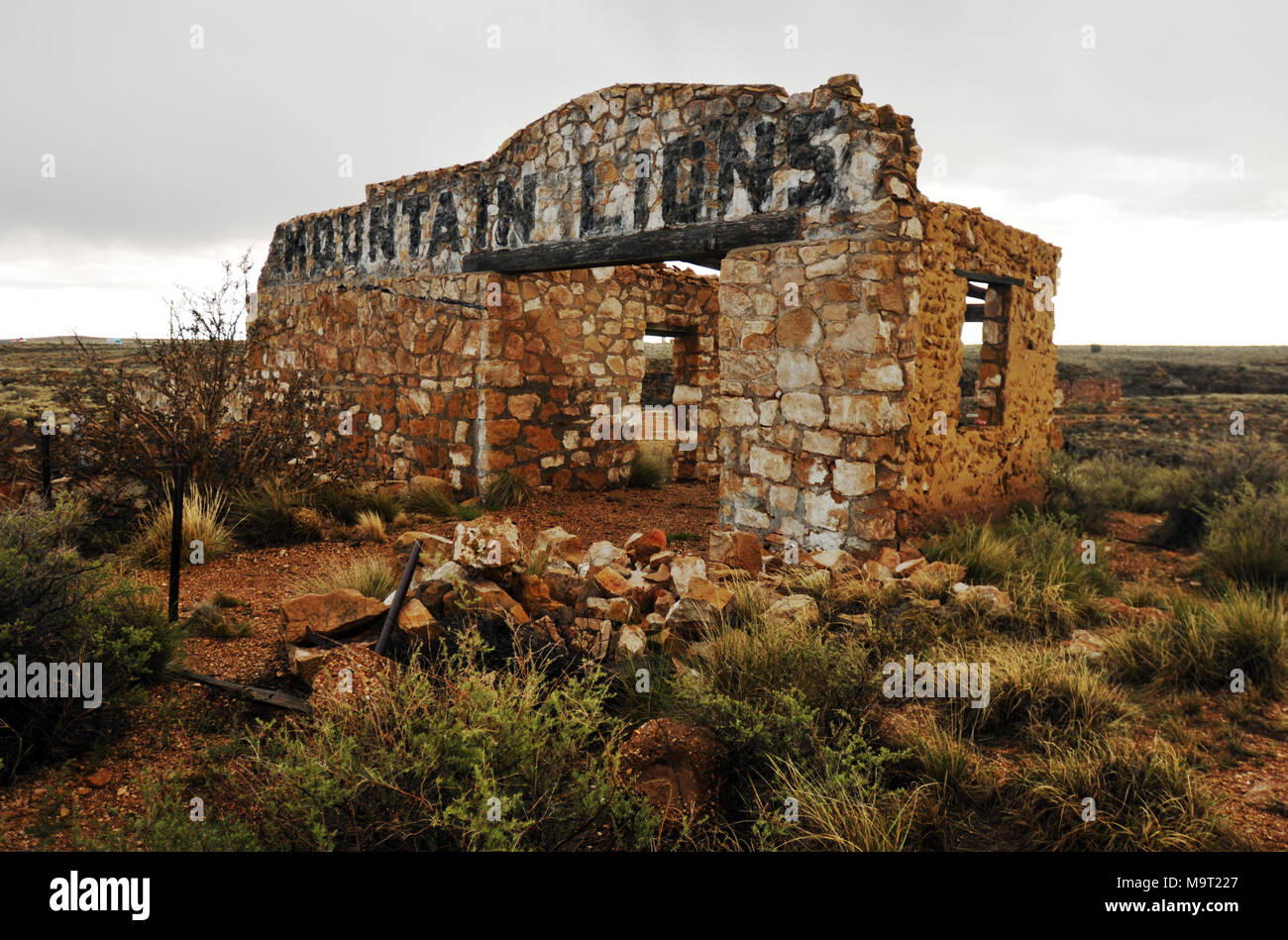 The crumbling stone mountain lion building stands at the abandoned roadside zoo in Two Guns, Arizona, once a popular tourist attraction on Route 66. Stock Photo