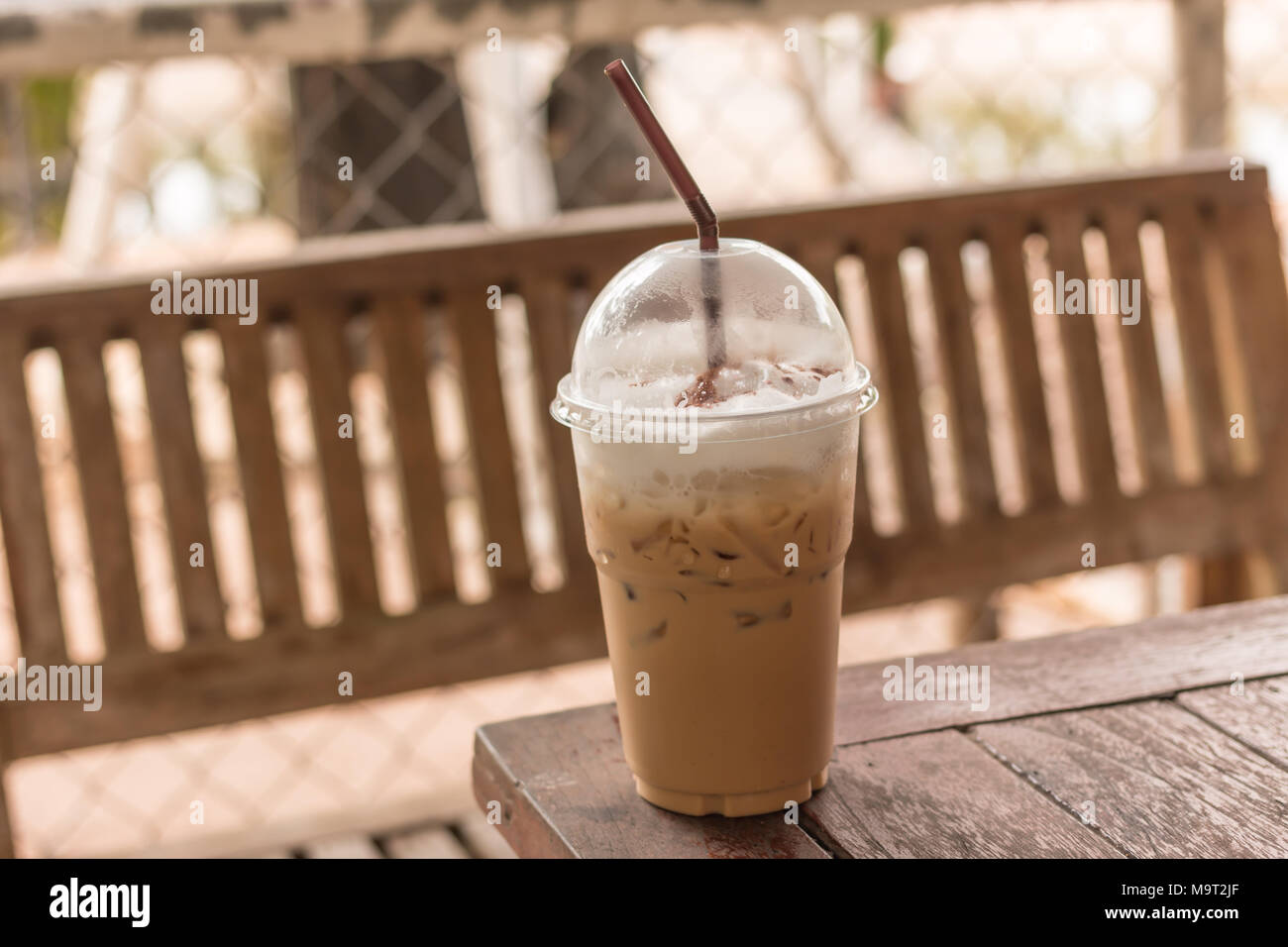 Fresh ice coffee in big plastic glass with straw Stock Photo - Alamy