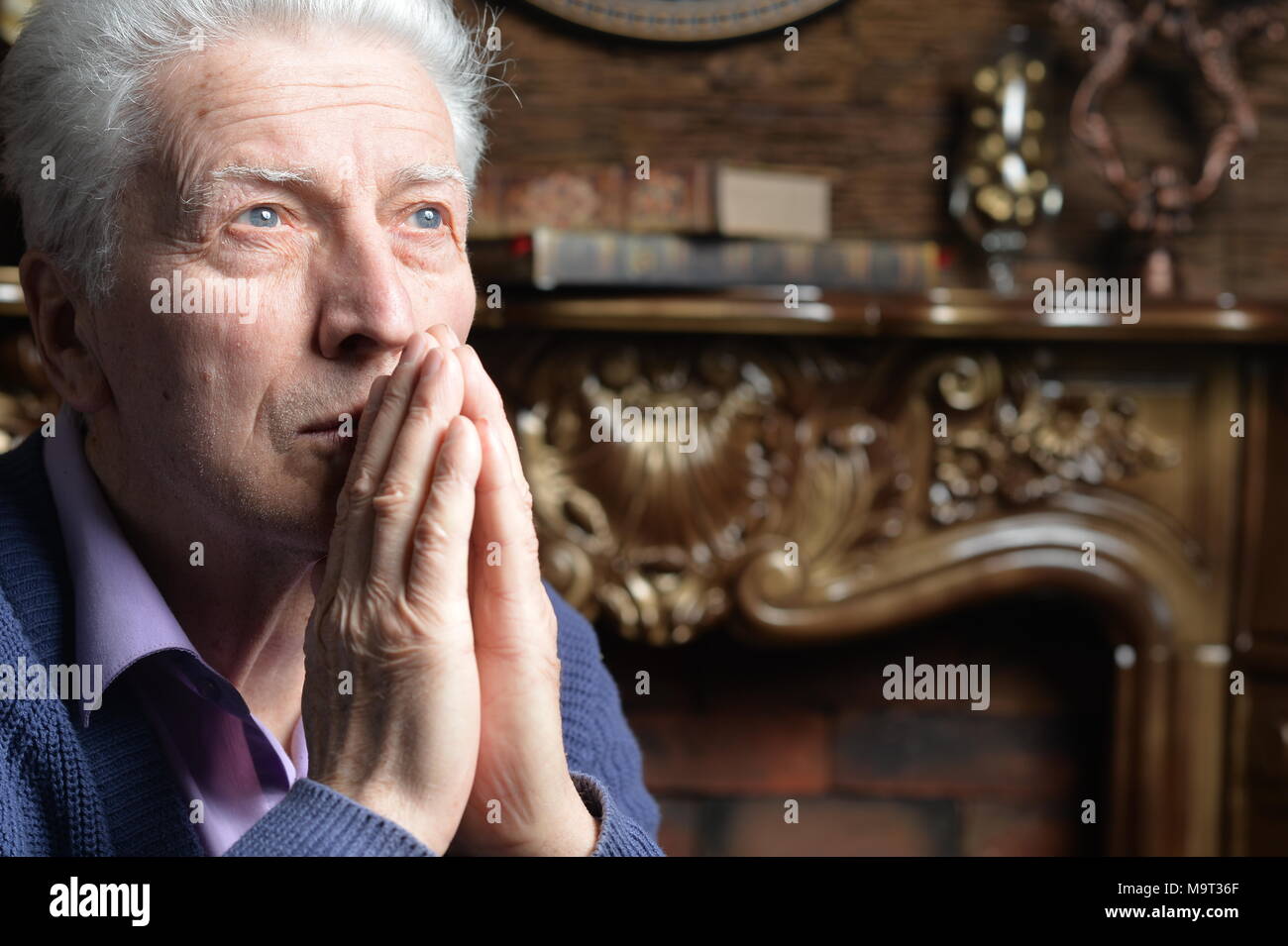 Senior man home praying hi-res stock photography and images - Alamy