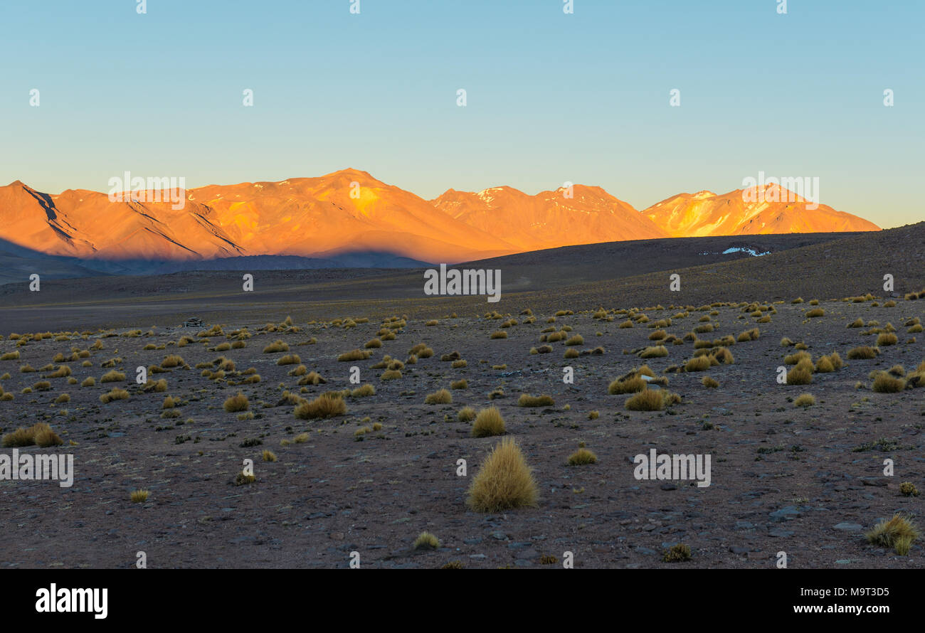 Sunrise in the altiplano of Bolivia in the Siloli desert at an altitude of 4600m near the border of Chile and the Atacama desert, South America. Stock Photo