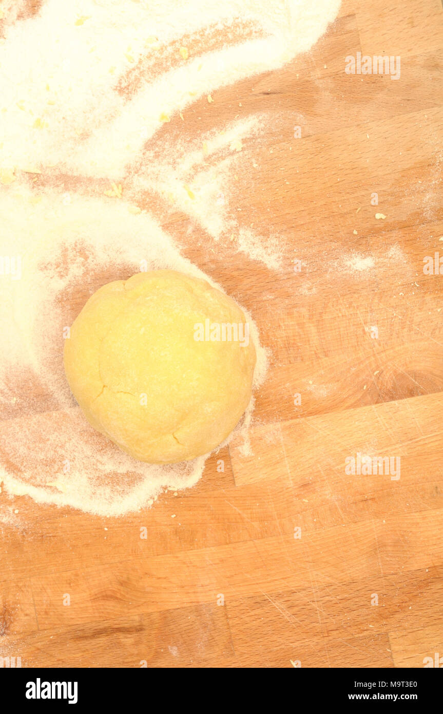 How to prepare Italian fettuccine, semolina flour and egg dough ready to be flattened, vertical from above Stock Photo