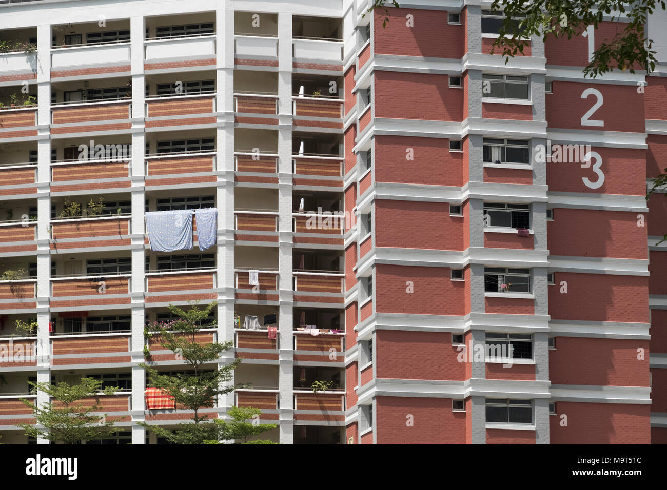 high-rise residential apartment building in Singapore with sheets hanging over balcony Stock Photo