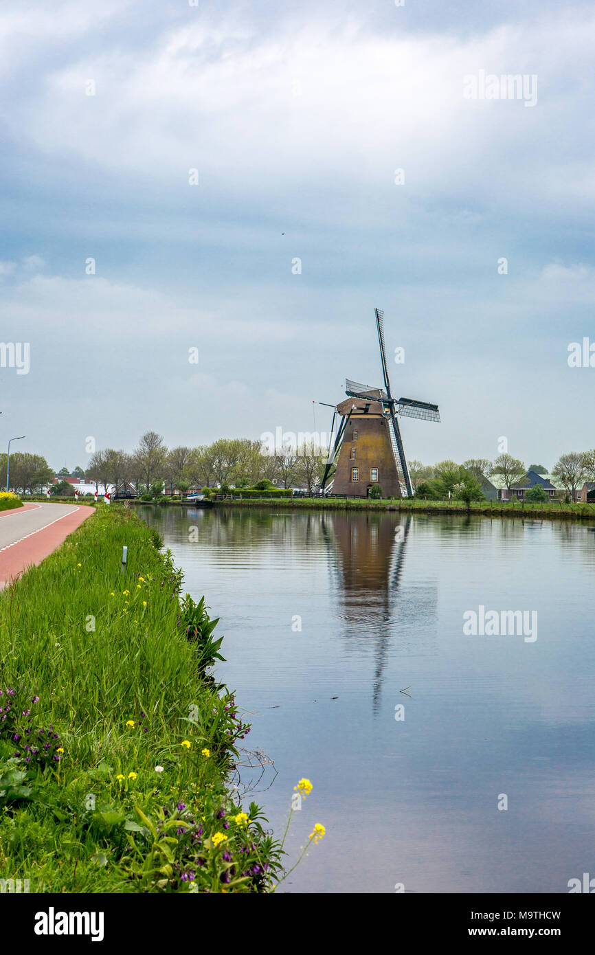 Windmill 'the Googermolen' with reflection in the water on the Ringvaart canal in Nieuwe Wetering the Netherlands. Stock Photo