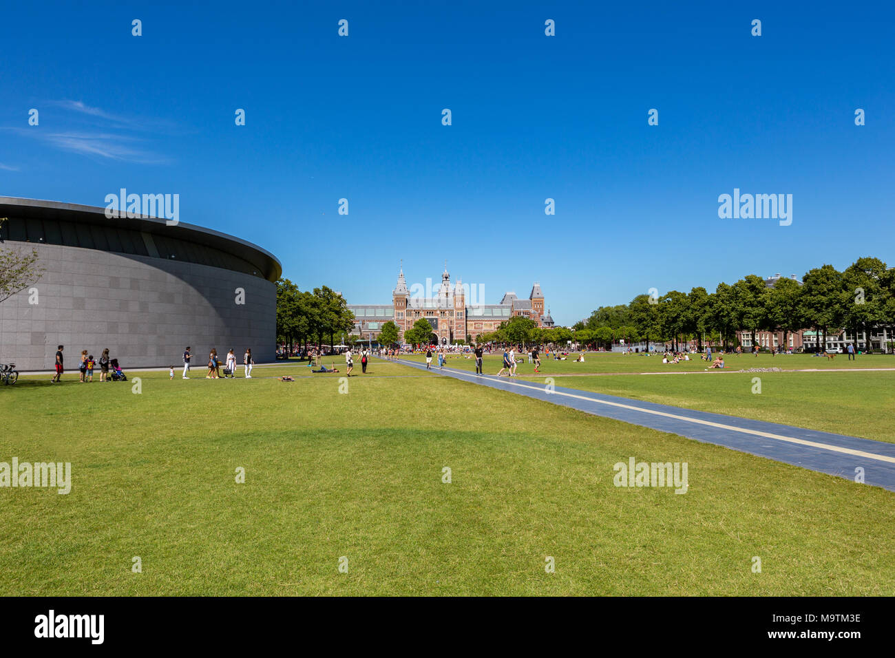 Tourists at the Rijksmuseum and the van Goghmuseum on the Museumplein in Amsterdam the Netherlands. Stock Photo