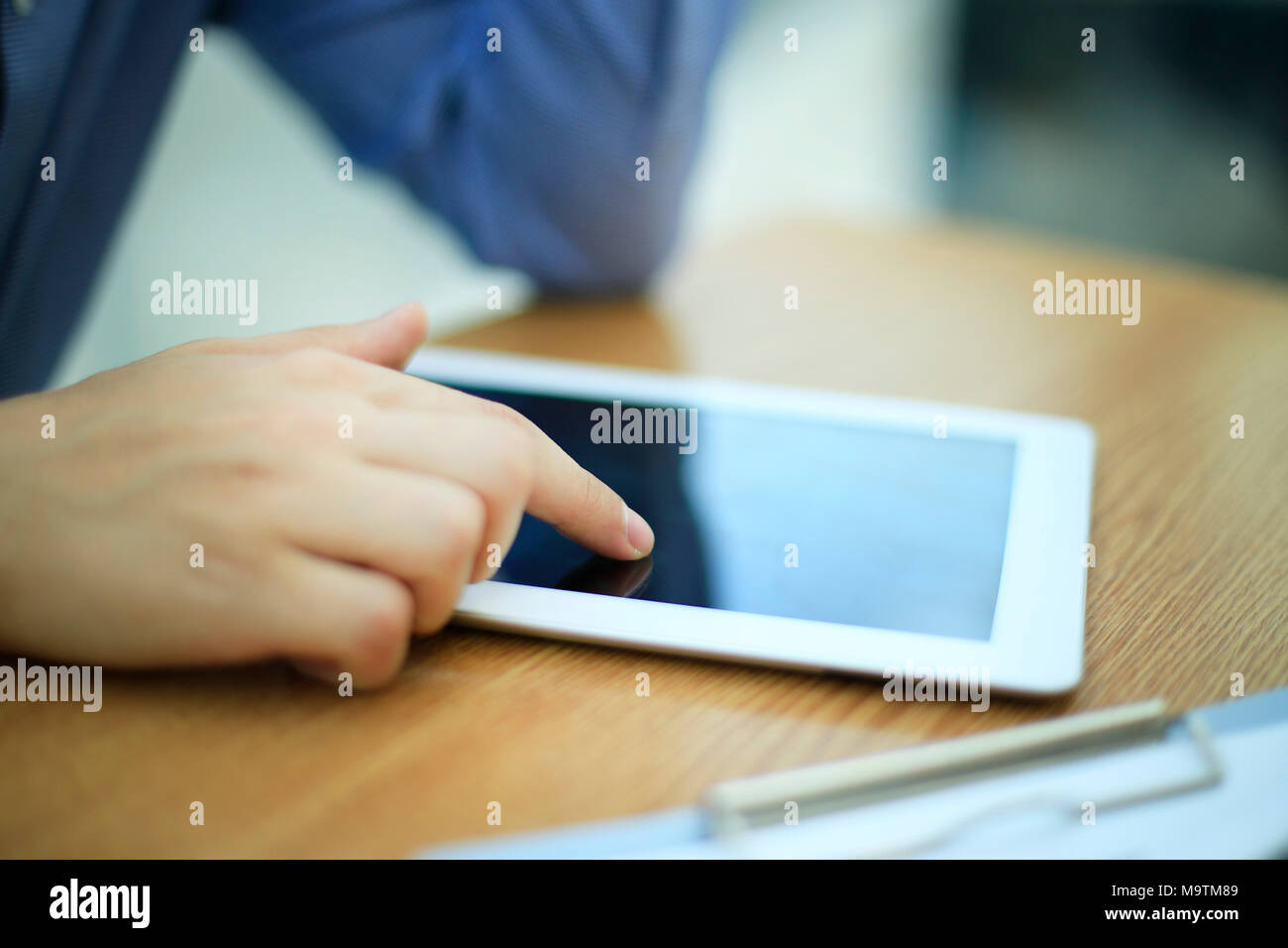 close up hands multitasking man using tablet, laptop connecting wifi Stock Photo