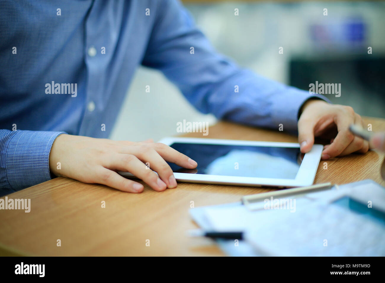 close up hands multitasking man using tablet, laptop connecting wifi Stock Photo