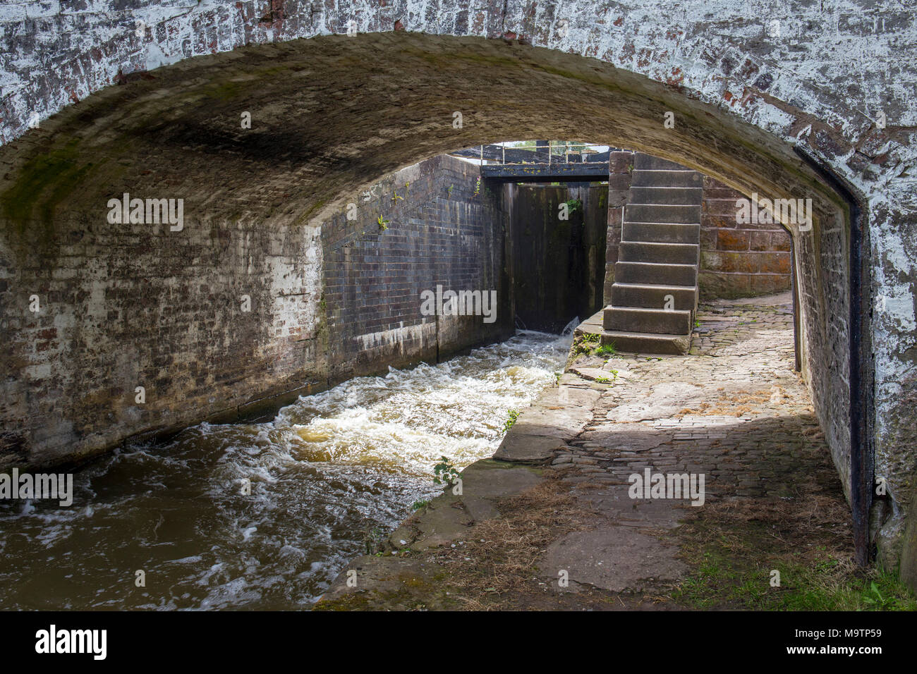 Canal lock with arch bridge in Cheshire UK Stock Photo
