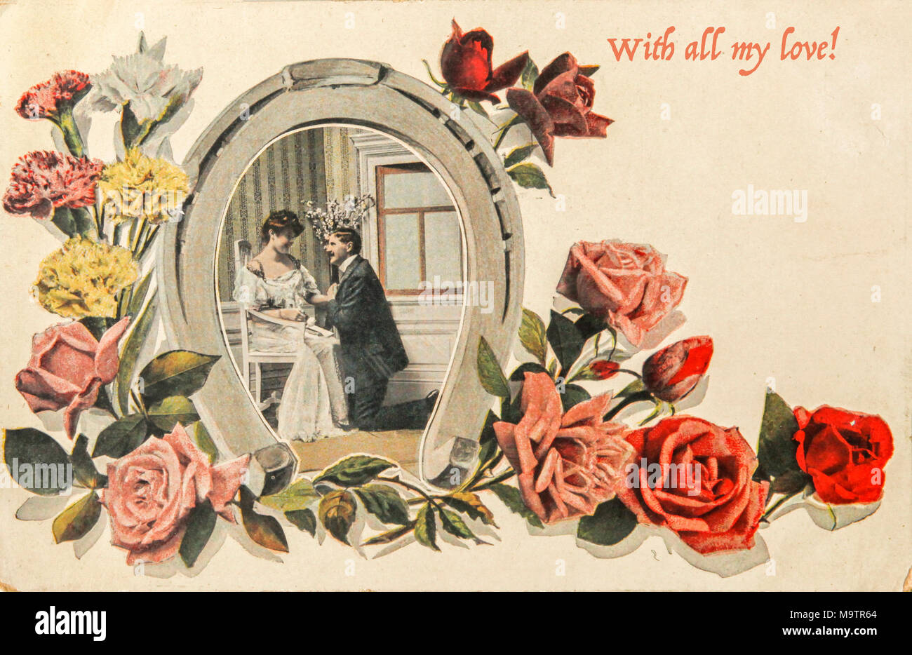 Vintage valentine card of 1915 with loving couple in horseshoe image with roses and text 'With all my love' Stock Photo