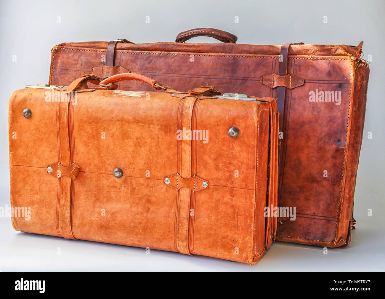 Two old weathered leather suitcases Stock Photo
