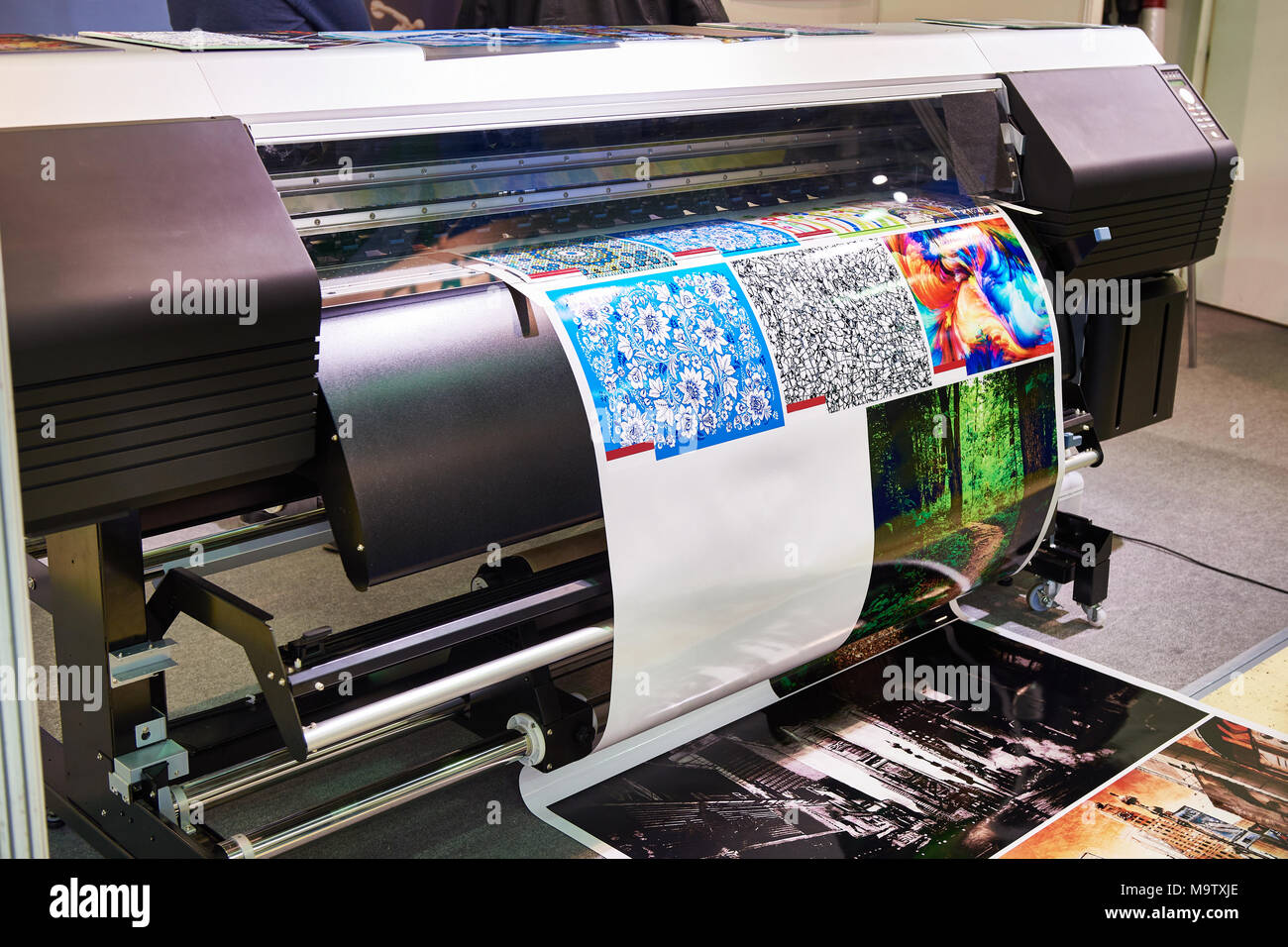 Big rolling wide plotter printer in work Stock Photo