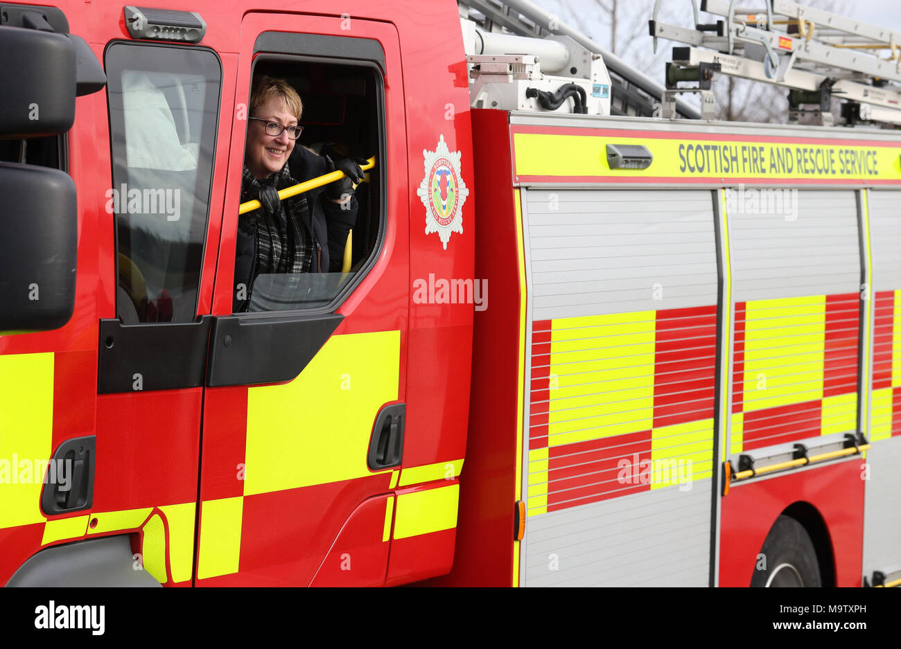 Community Safety Minister Annabelle Ewing looks out from a fire engine after she was given a live water rescue demonstration at Falkirk's Helix Park, as she helps mark five years of the Scottish Fire and Rescue Service. Stock Photo