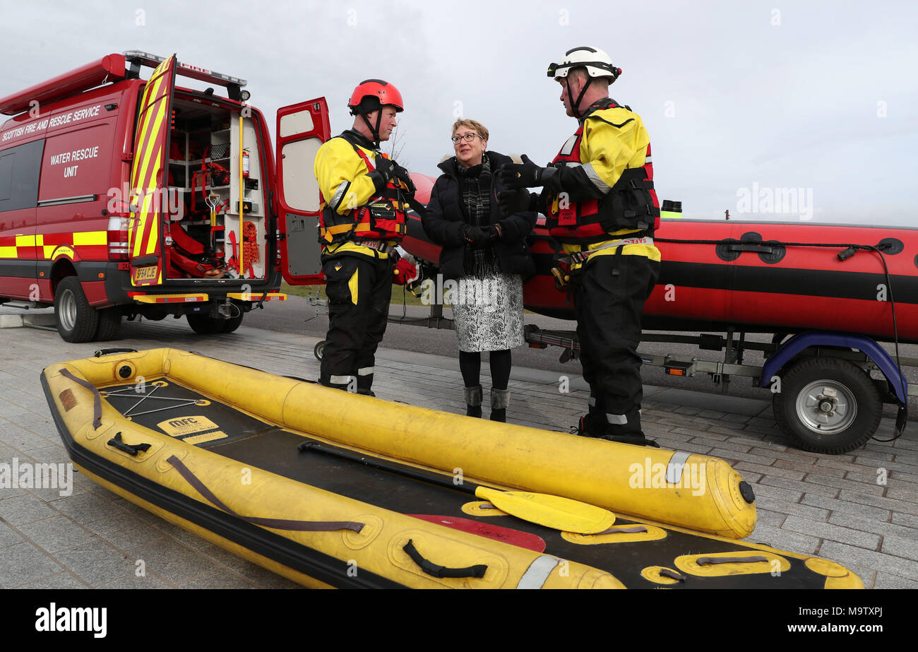 Community Safety Minister Annabelle Ewing chats with firemen Scott Westworth(L) and Gary Barker from Bathgate fire station after she was given a live water rescue demonstration at Falkirk's Helix Park, as she helps mark five years of the Scottish Fire and Rescue Service. Stock Photo