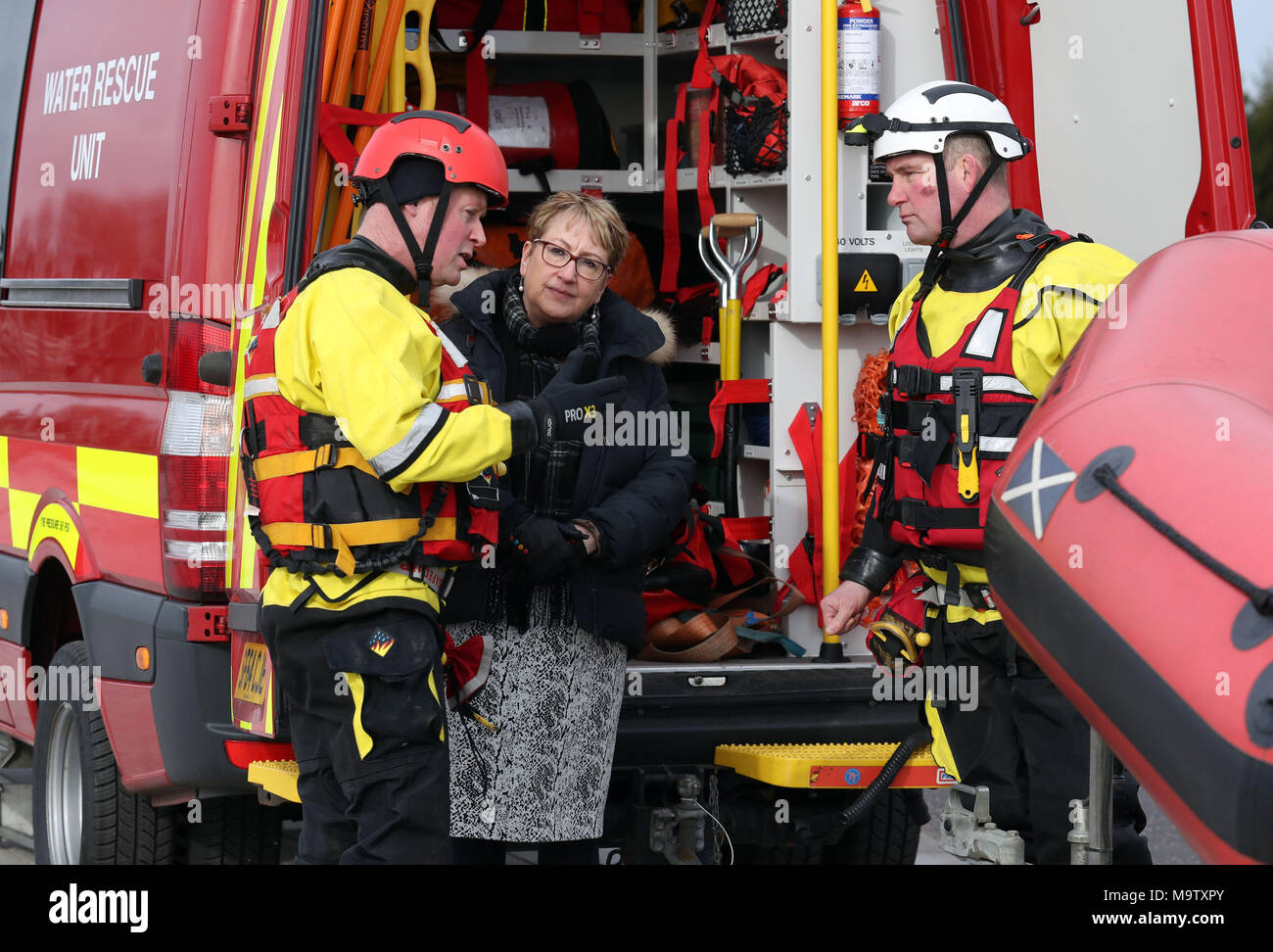 Community Safety Minister Annabelle Ewing chats with firemen Scott Westworth(L) and Gary Barker from Bathgate fire station after she was given a live water rescue demonstration at Falkirk's Helix Park, as she helps mark five years of the Scottish Fire and Rescue Service. Stock Photo
