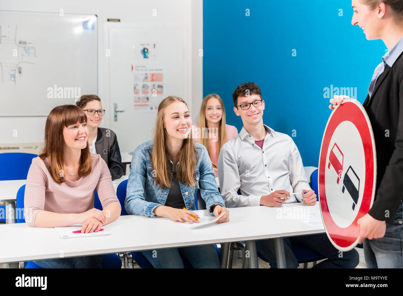 Students listing to their teacher in driving class Stock Photo
