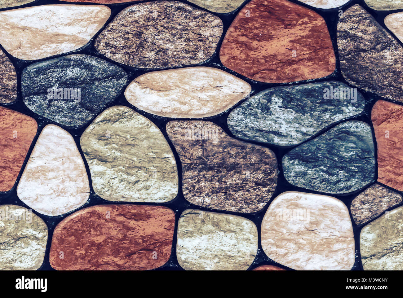 Seamless texture of rounded multi-colored marble stones. Stone wall finish with rounded edges Stock Photo