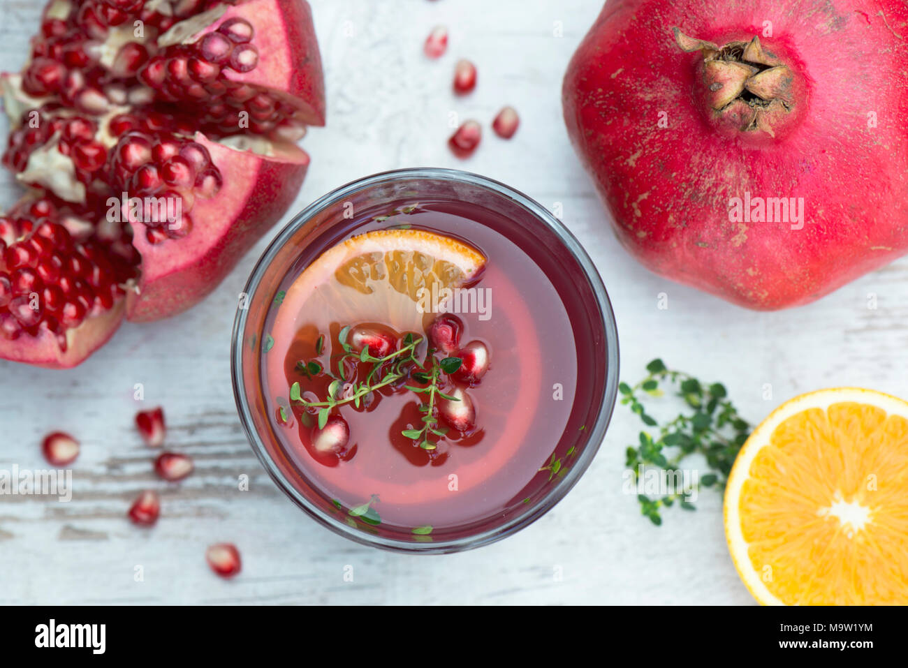 Fresh pomegranate juice with orange and lemon thyme, healthy drinks Stock Photo