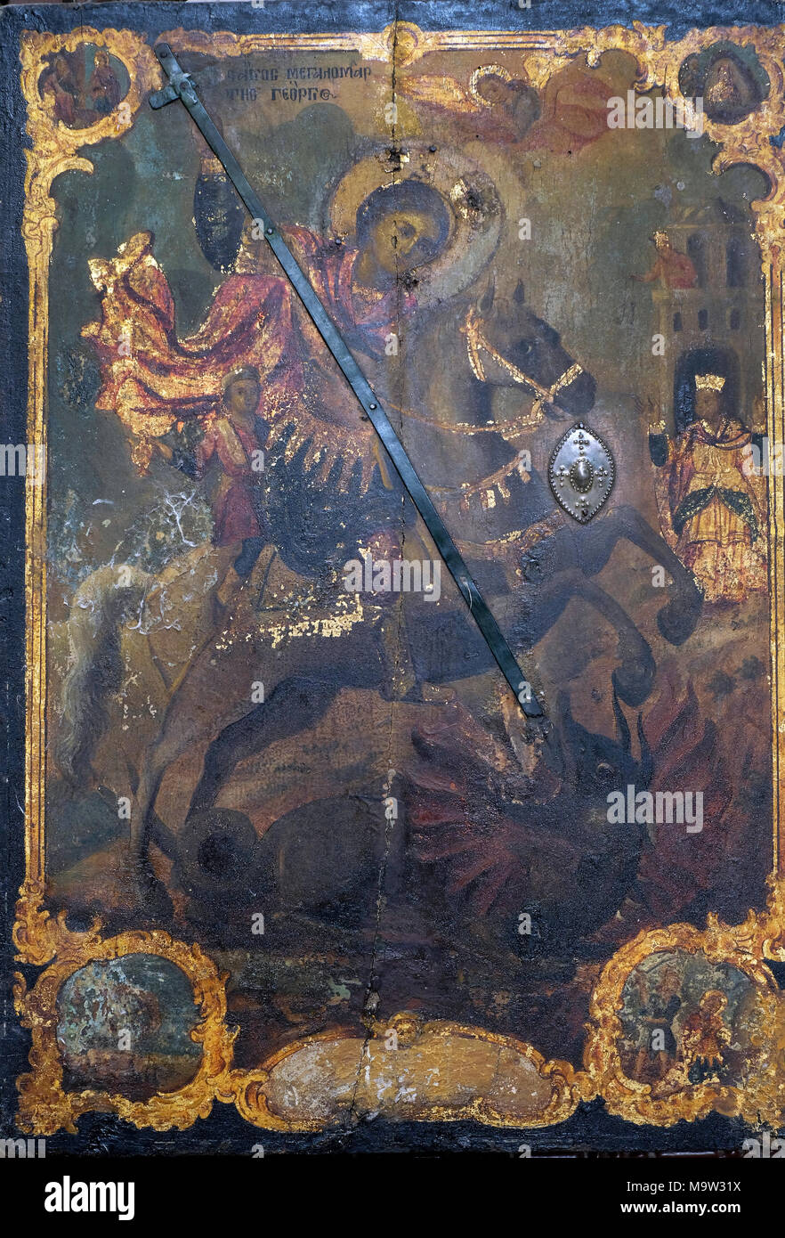 An old painting depicting an orthodox Christian legend in which Saint George slays a dragon that demanded human sacrifices placed at the Greek Orthodox Chapel of St John and baptistry in which Arab Christians pray located next to the Church of the Holy Sepulcher, on the Western wall of the square.in the Christian Quarter old city  East Jerusalem Israel Stock Photo