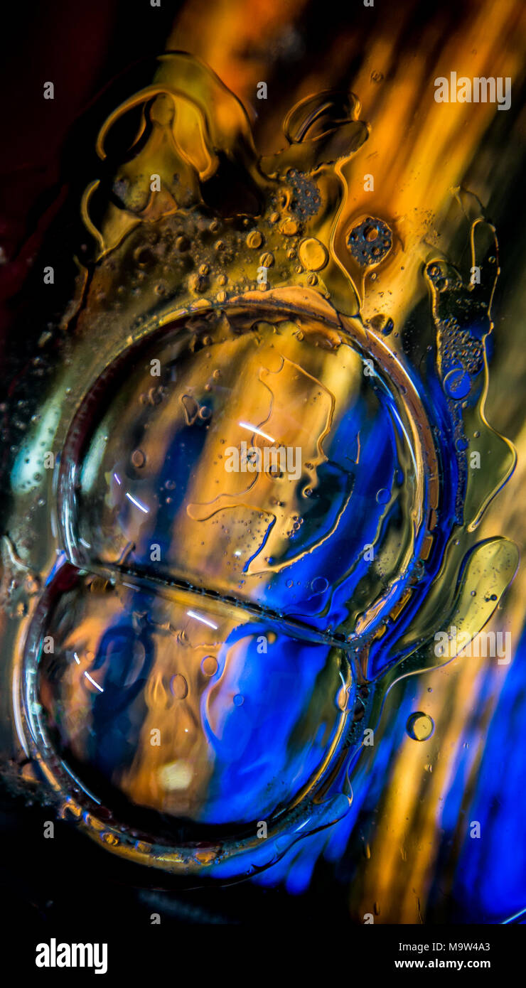 Psychedelic colours bubbles over coloured glass. Stock Photo