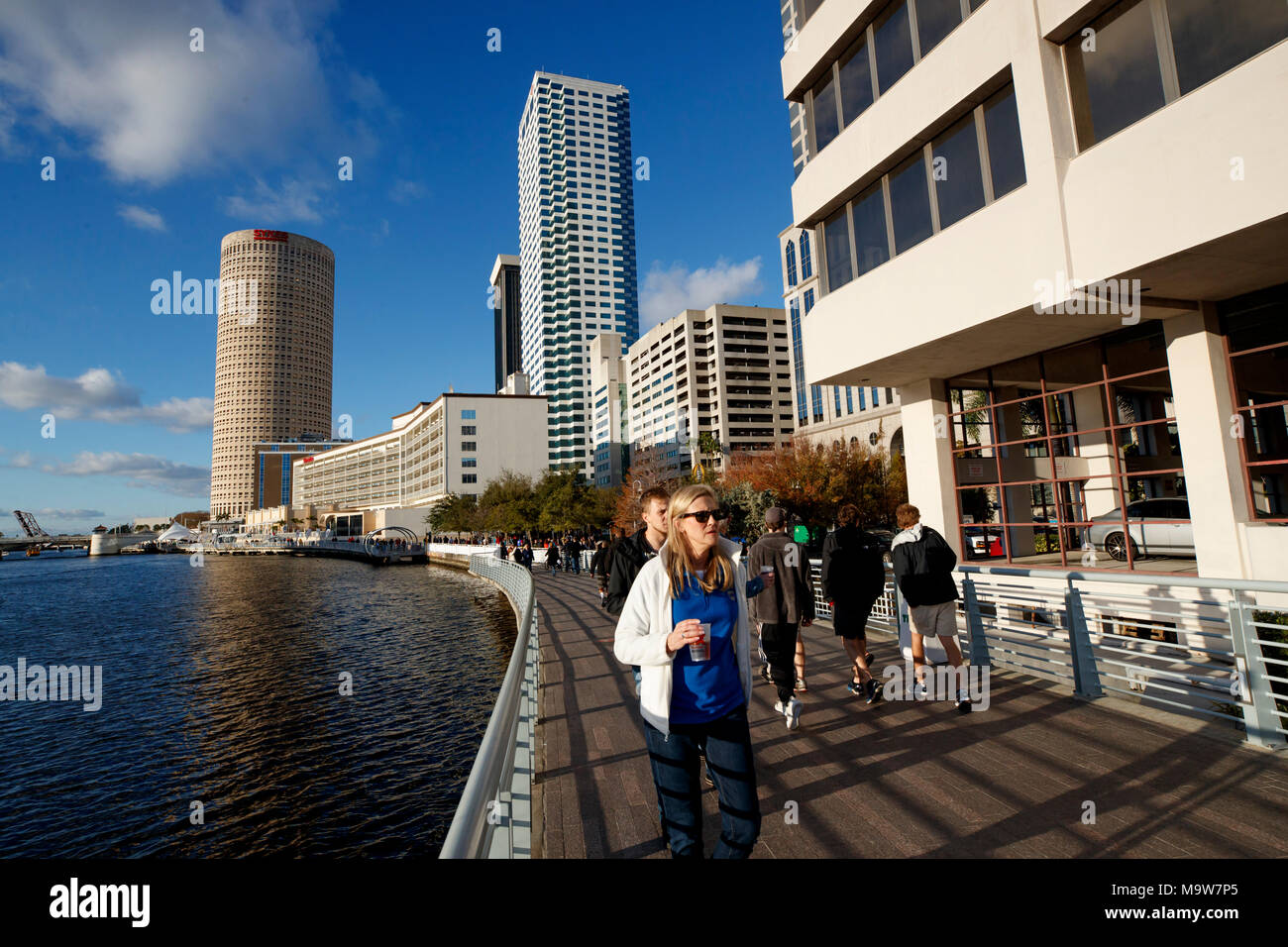 Visitors walk the Tampa Riverwalk over the Hillsborough River during the 2017 College Football Playoff celebrations in Tampa, Florida. Stock Photo