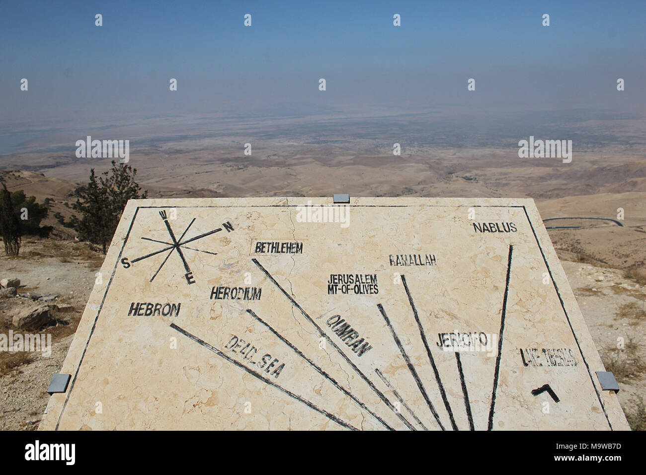 View from Mount Nebo over the surrounding countryside with an orientation table indicating key locations in Israel and Palestine. Stock Photo