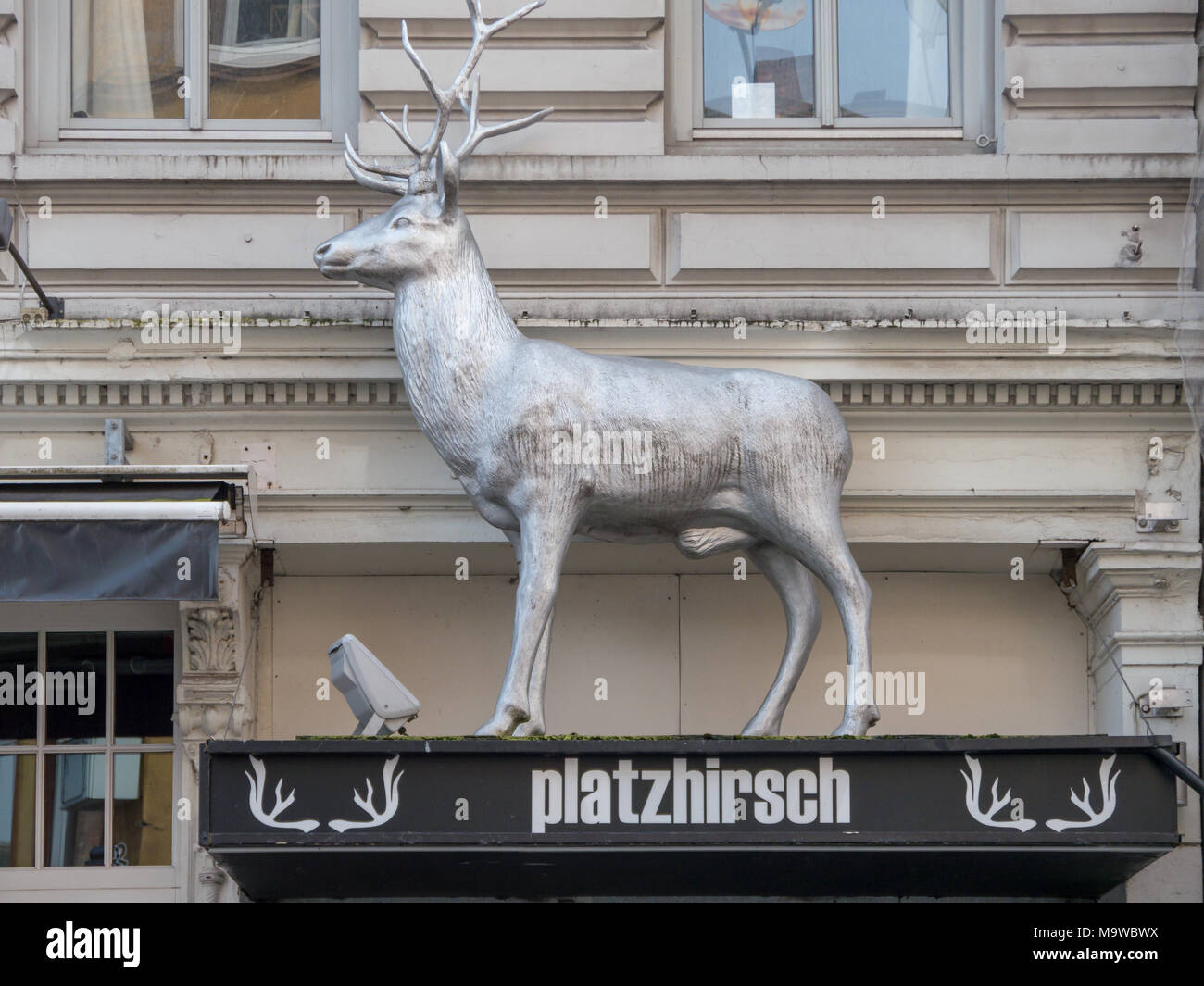 Hamburg, Germany - April 03, 2016: Statue of a male deer, stag, at roof of entrance to club platzhirsch in Hamburg, St. Pauli. Stock Photo
