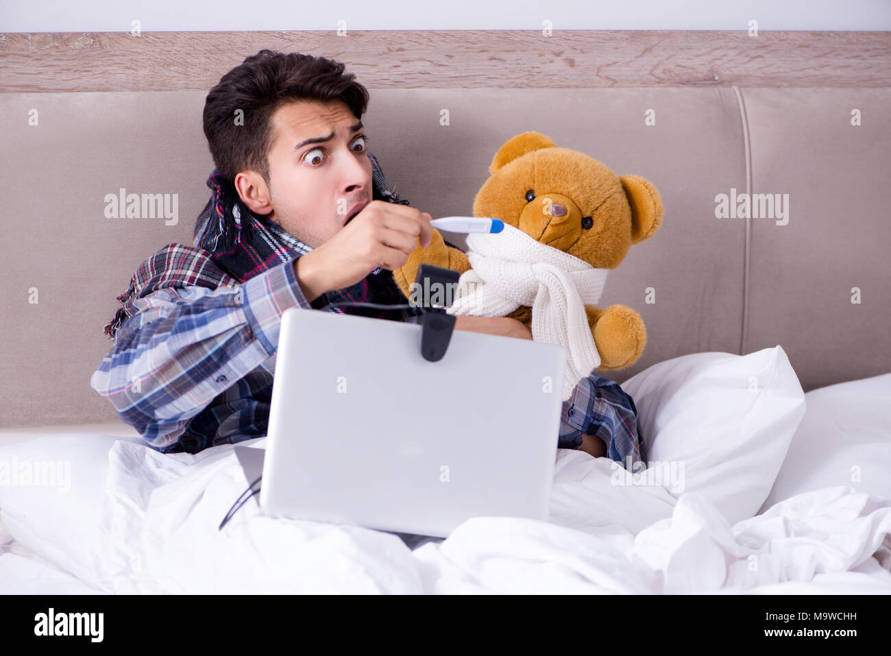 Sick man suffering from flu in the bed Stock Photo