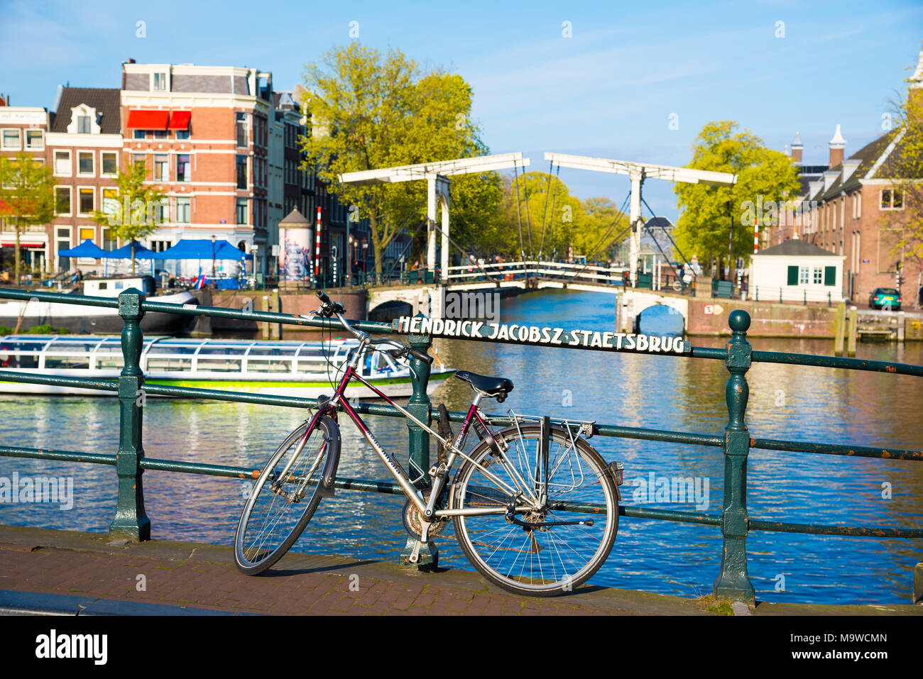 Amsterdam, Netherlands - April 19, 2017: Bikes on the bridge in Amsterdam, Netherlands. Stock Photo