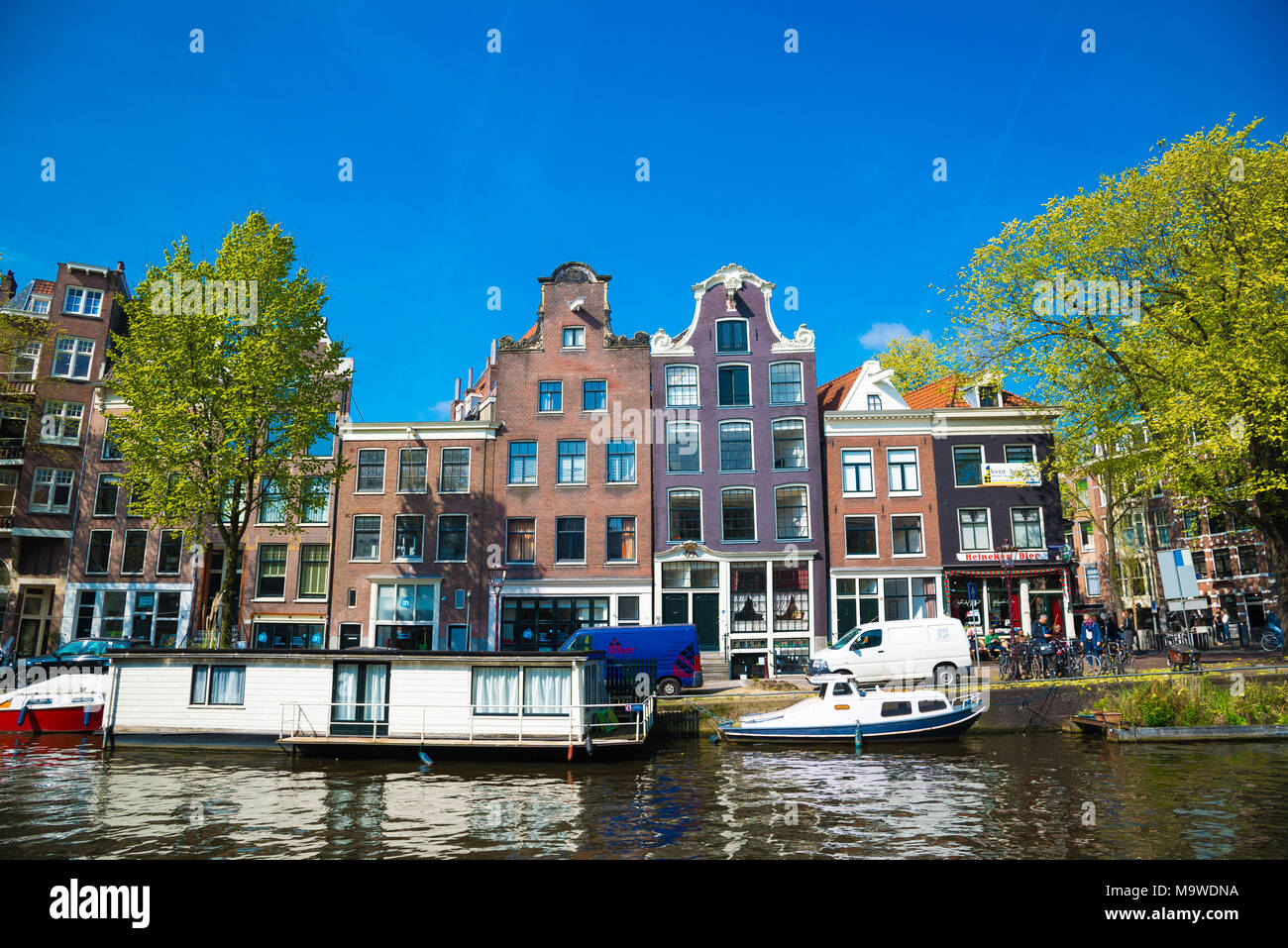 Amsterdam, Netherlands - April 20, 2017: Amsterdam canal and beautiful traditional old buildings, Netherlands Stock Photo