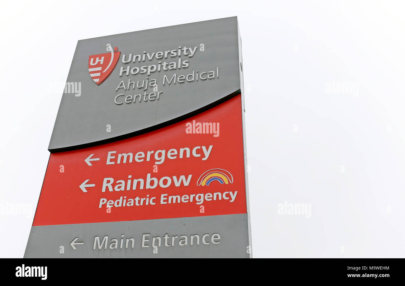 A large sign directs people at the entrance road to University Hospitals Ahuja Medical Center in Beachwood, Ohio, USA. Stock Photo