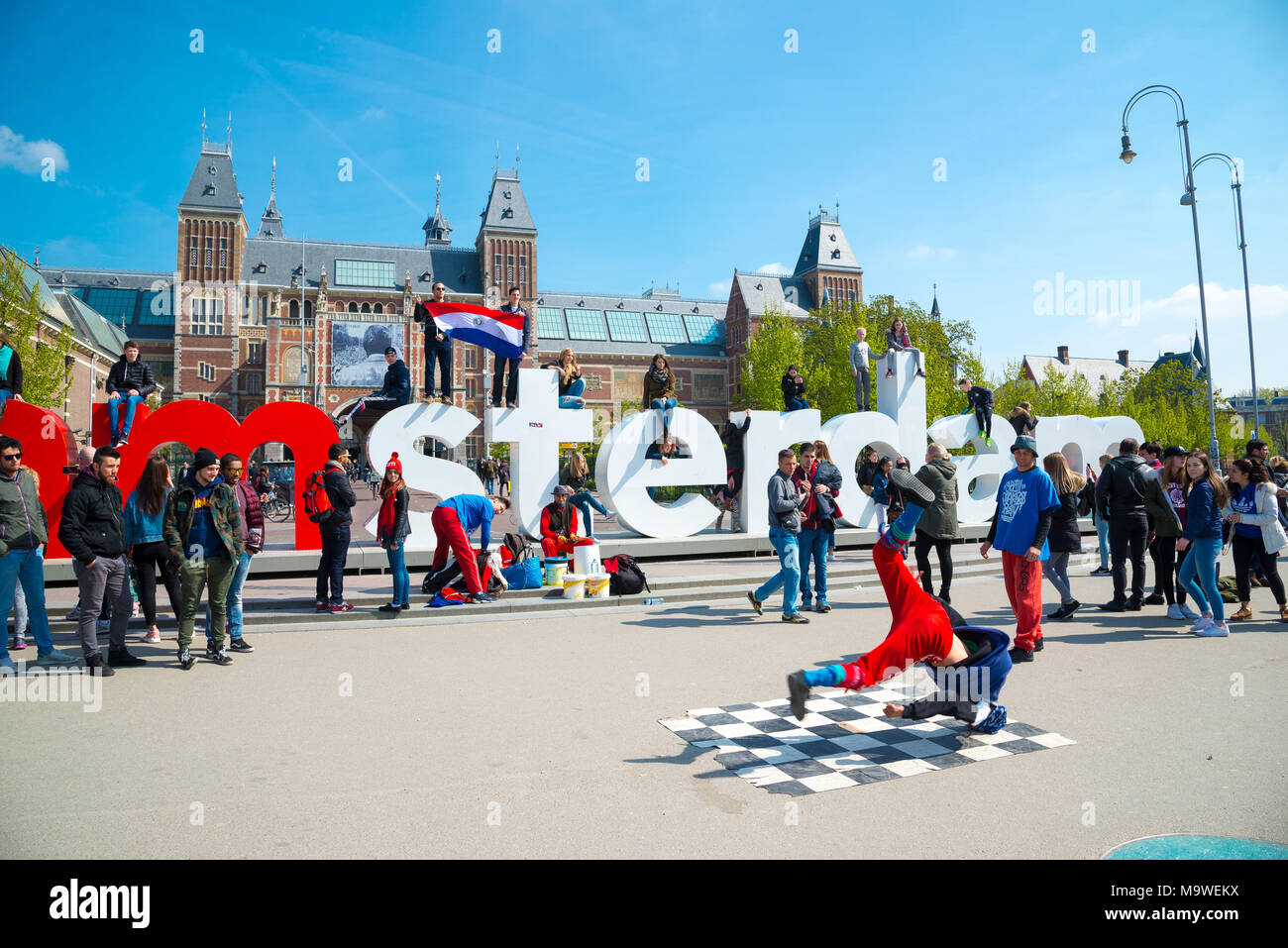 Amsterdam, Netherlands - April 20, 2017: Youth break dancing on city streets in Amsterdam. Street festival breakdance. Stock Photo