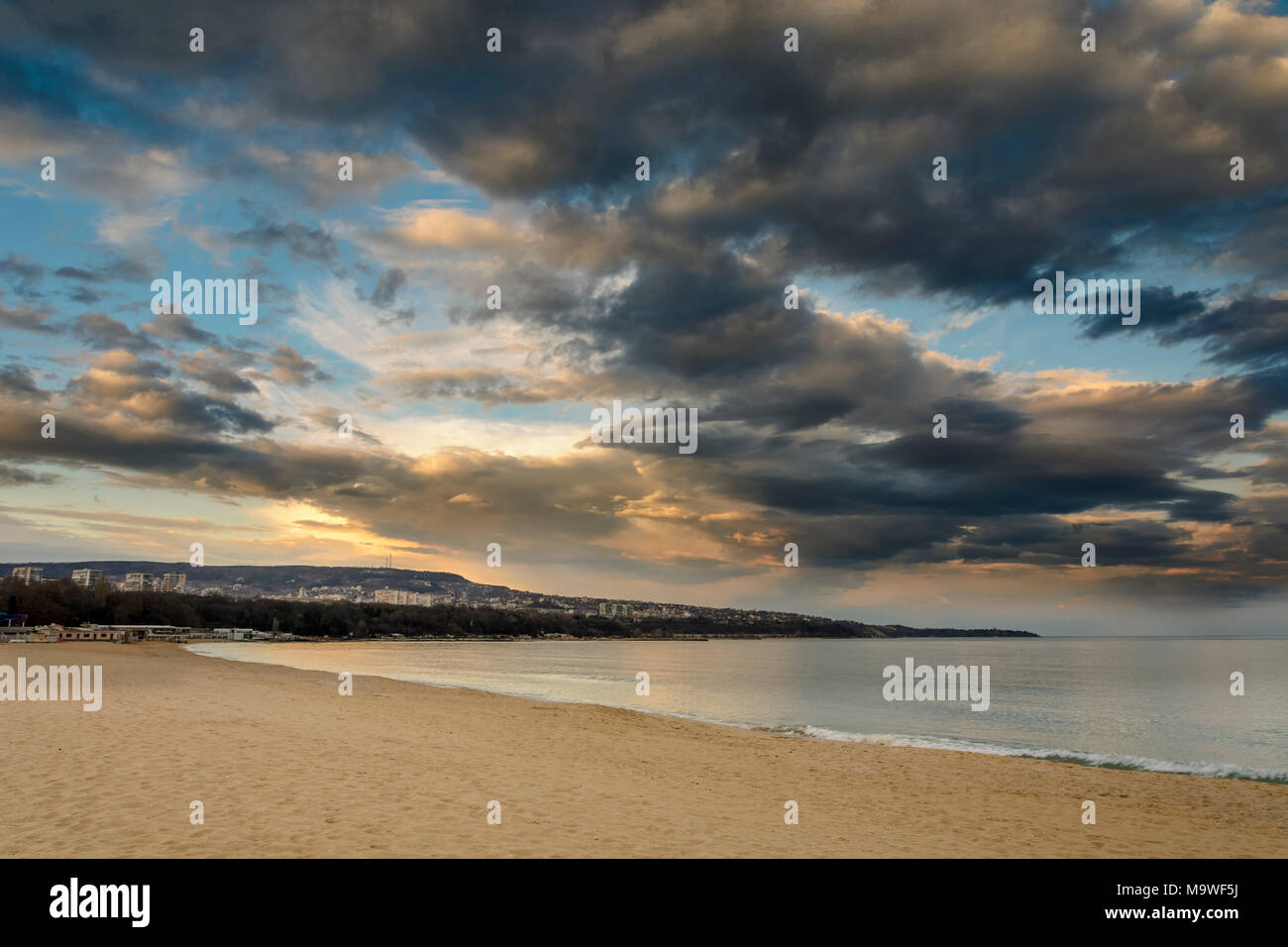 Beach at sunset, Dramatic clouds over the sea Stock Photo - Alamy